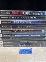 Photo showing 9 PS2 game cases stacked horizontally, titles clearly visible on spines.