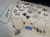 Photo showing a diverse collection of silver-tone costume jewellery pieces including bracelets, earrings, and necklaces mostly from Alpaca Mexico.