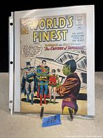 Photo of World's Finest Comics issue #5 comic book, showing front cover with Batman, Robin, Superman and alien character.