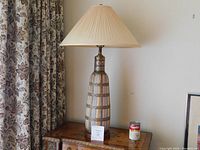 Full view of lamp on table with shade