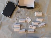 Assortment of gemstones and storage box removed from box showing plastic bags and envelopes