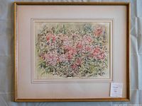 Framed watercolour painting of abstract pink flowers with green foliage, showing overall look within gold-tone frame and cream mat with hand-painted accents.