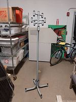 Full view of the coat stand showing its height and overall structure with hooks and base visible.