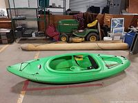 Left side profile view of green kayak showing overall shape and size.