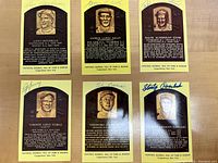 All 6 Hall of Fame baseball player autographed postcards laid out showing front with signatures and artwork.