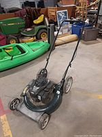 Full angled front-left view of the Bolens lawn mower showing metal deck, engine, wheels and handlebar.