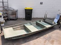 Left-side profile of green aluminum flat-bottom boat with three bench seats