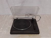 Front view of the Kenwood KD-36R turntable with dust cover closed showing the platter and tonearm.