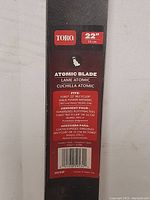 Close-up of product label showing Toro branding and blade size (22 inches) and compatibility details