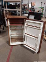 Open fridge interior viewed from slightly different angle showing shelves and door storage.