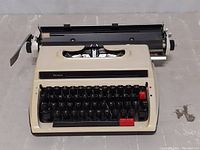 Front view of vintage Sears manual typewriter showing keyboard and brand label.