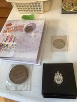 Coins arranged on table with a birthday card and black presentation box showing Canada's crest