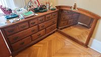 Full view of the Kroehler wooden dresser with attached large mirror and decorative handles, showing surface condition and overall style.