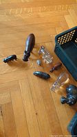 Hippo and other figurines displayed on wooden floor, showing various materials and sizes.