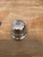 Top view of closed sterling silver ring box with BB logo on lid