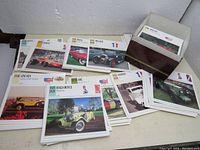 Photo showing large quantity of classic car knowledge cards and dividers spread out with storage box
