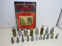 View of all air fittings and sealed combination air tool package arranged on a white surface.