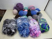 Overview of assorted yarn balls in multiple colors and conditions