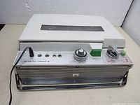 Front view of the Crowncorder CTR 5400 tape recorder with control knob, mic jack, and roller tape mechanism covered.