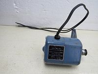 Blue motor unit with power cord, showing general condition and structure.