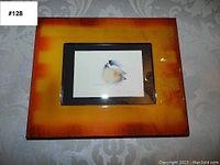 Front view of the framed bird print with visible artwork and frame details.