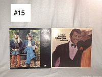 Front view of the ABBA Greatest Hits and The Dean Martin Television Show vinyl records jacket covers showing album artwork and titles.