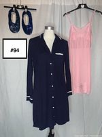 Full view of all three items: navy blue button nightgown on mannequin, pink lace slip next to it, and blue sequin slippers hanging above.