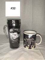 Front view of Elvis Presley travel insulated mug with grayscale photo and red signature, next to Beatles Abbey Road ceramic coffee mug showing Abbey Road image.
