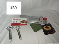 Full lot with pasta sheet slicer, two peelers, instruction manual, and recipe booklet.