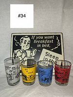 Four colorful vintage bowling gag shot glasses displayed on a gray fabric background.