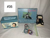 Full lot photo showing four items together: recipe box, tin sign, cat light switch cover, and clips