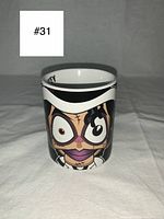 Front view of the coffee mug showing the cartoon zombie character resembling Michael Jackson with exaggerated eyes and stitches.