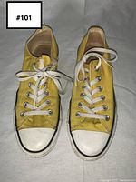 Front top view of both yellow Converse sneakers showing condition and lacing.