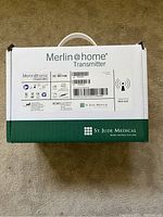 Box of Merlin@home EX1150 transmitter labeled with model and certifications, unopened and in good condition
