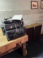 Sony stereo rack system with multiple components including turntable, cassette decks, CD player, and wiring on a wooden table.