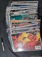 Multiple comic books mostly Hulk and some The Spirit, individually bagged in protective plastic sleeves
