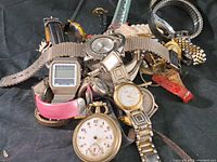 Overview of mixed bulk lot of vintage wristwatches showing variety in bands, dial types, and styles