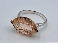 Ring front view showing the marquise cut orange topaz stone in silver setting.