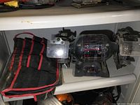 Side view of Craftsman bench grinder and accompanying storage bag on shelf