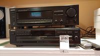 Photo of stacked Sony Audio/Video Control Center and Sony 10-disc CD Changer with digital displays and front control buttons, with remote controls placed beside.
