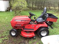 Full side profile showing mower body, deck, wheels and attached grass cart