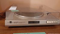 Front view of Dual CS 530 belt drive turntable with closed dust cover showing buttons and display.