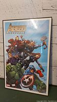 Framed Avengers Assemble Marvel print showing Iron Man, Thor, Black Widow, Hawkeye, Hulk, and Captain America on blue background.