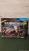 Game box for Cabela's Survival: Shadows of Katmai with front cover visible showing PlayStation Move compatibility and special edition sticker