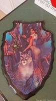 Full view of the decorative wall clock with artwork of a woman and a cougar, mounted on a shaped wooden plaque