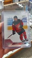 Front view of Connor Bedard hockey card showing player in Team Canada Juniors uniform with number 16.