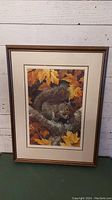 Full view of the framed art print showing the squirrel amidst autumn leaves.