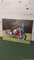 Photo of wooden picture print showing Harley Davidson Electra Glide motorcycle outdoors against a white wooden wall, highlighting front and side of the motorcycle print.