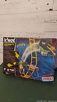 Front view of the K'NEX Hyperspeed Hangtime roller coaster box showing the roller coaster track and meteoric themed coaster car model graphic.