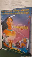 Front view of the wood picture print showing Pocahontas and other characters along with Disney branding and video release text.